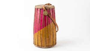 Traditional Folk Musical Instrument Mandar from Jharkhand featuring vibrant pink and yellow colors and leather straps, representing tribal culture and its new GI Tag.